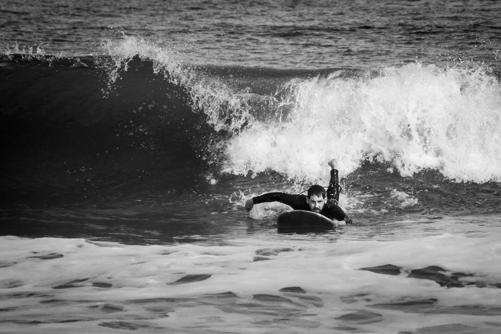 Here he is paddling for a wave