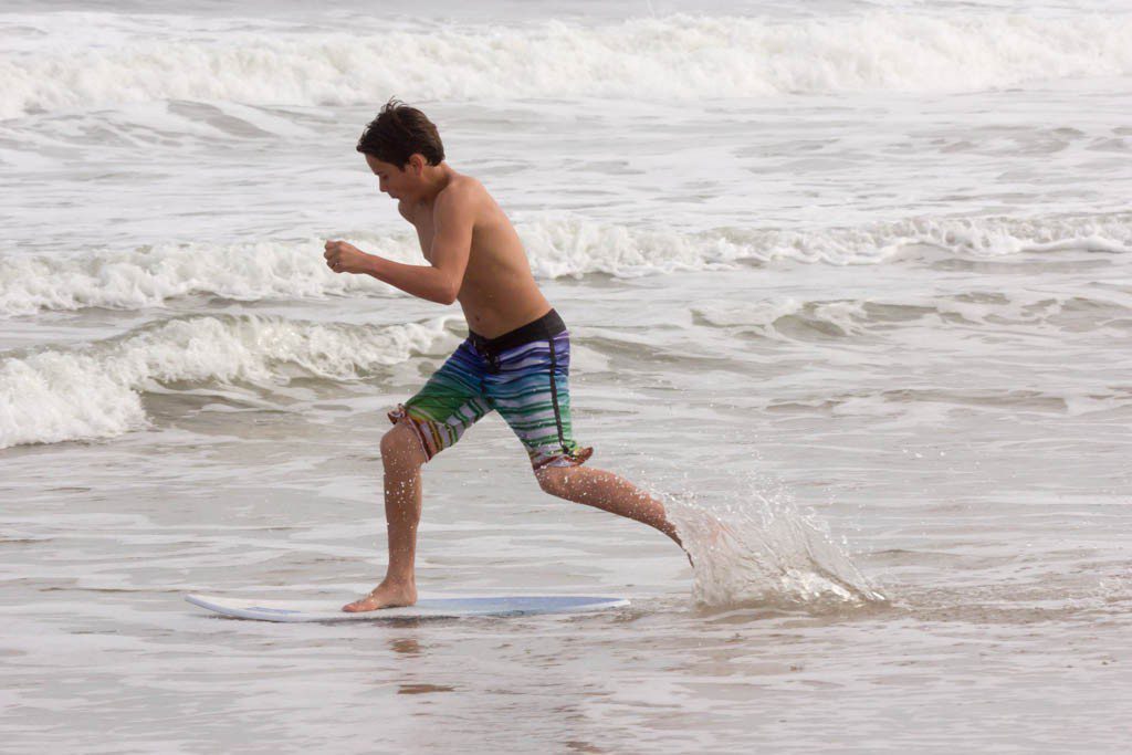 Kid skimboarding