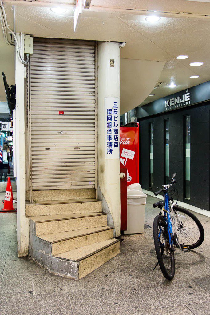 Bicycle by stairs and a door that go...up? I have no idea. I never really thought about where that went until just now...