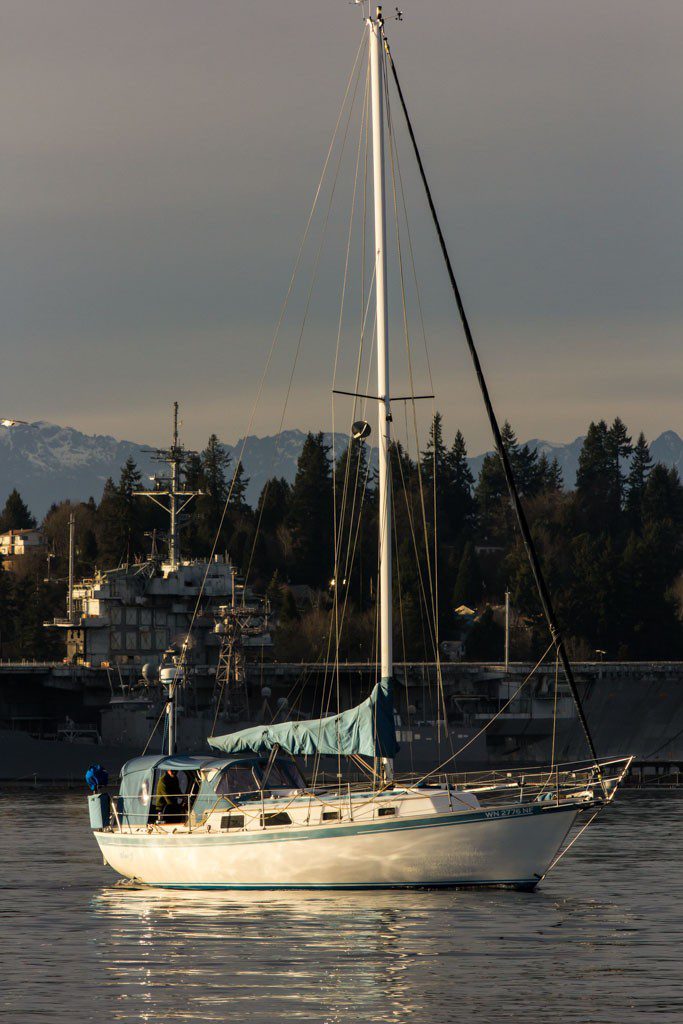 Our little blue boat in front of the big gray ships!