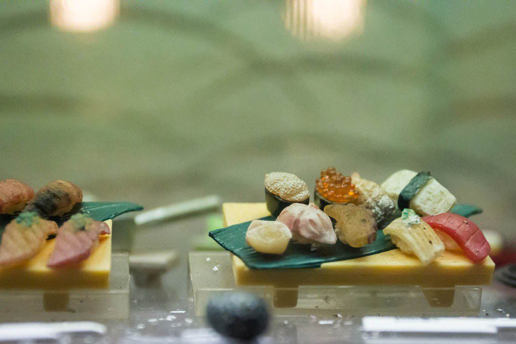 Tiny food display in a window. The whole sushi tray was only a few inches long.  Most of the restaurants have the realistic food in the windows, but this one was so small I needed a photo of it!