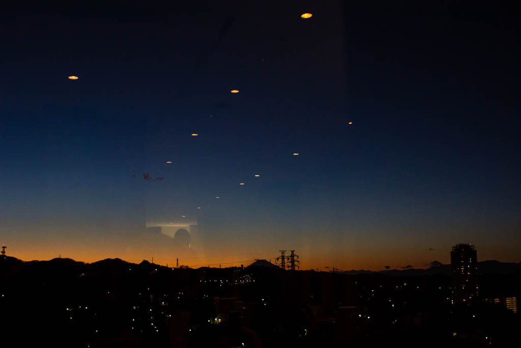 Shot from the window of the 19th floor at breakfast on Saturday.  Mt. Fuji is in the background and I thought the reflections in the glass were interesting. 