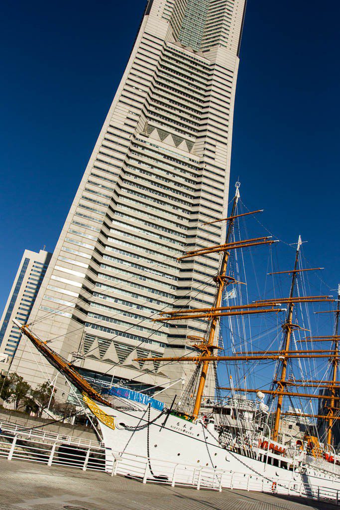 Contrast between the old ship and the new skyscraper