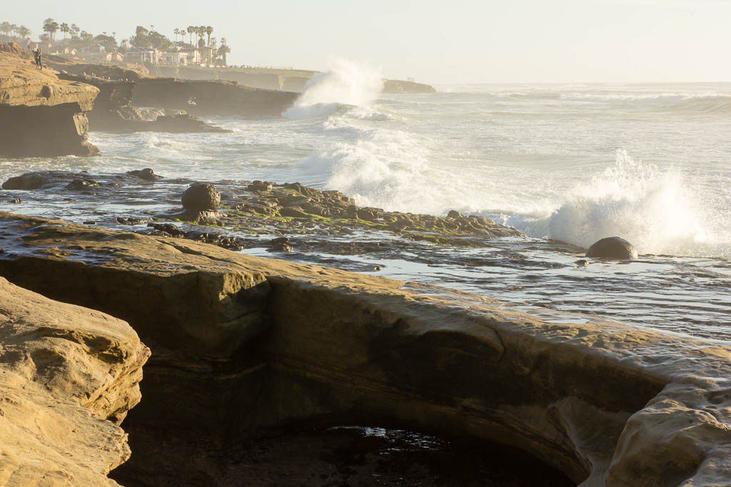 Waves crashing into the rocks at high tide