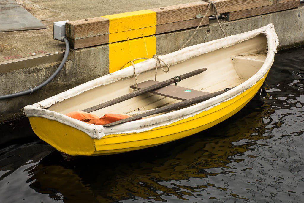 Yellow boat against a yellow dock. 