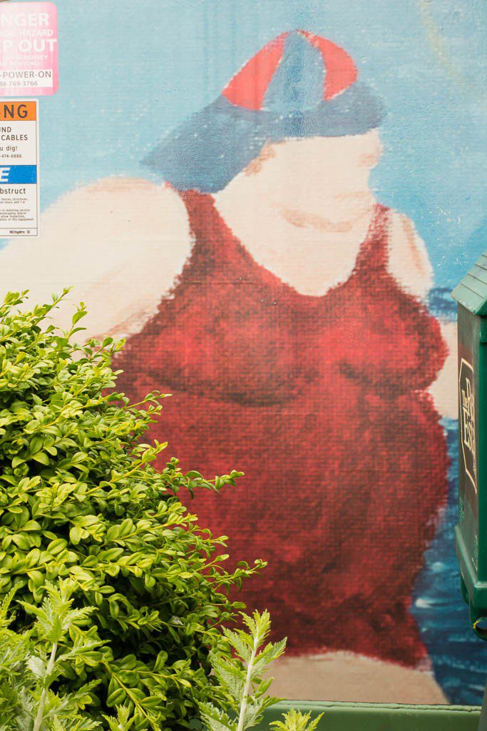 People in bathing suits on the electrical enclosures.