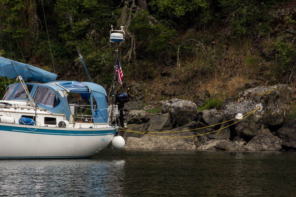 This is a stern tie.  We have a spool of rope hanging on the back of the boat. It's ran through a ring anchored to that bigass rock. Neat, huh?