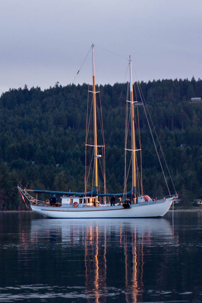 Old ship with the masts lit up from the sunset