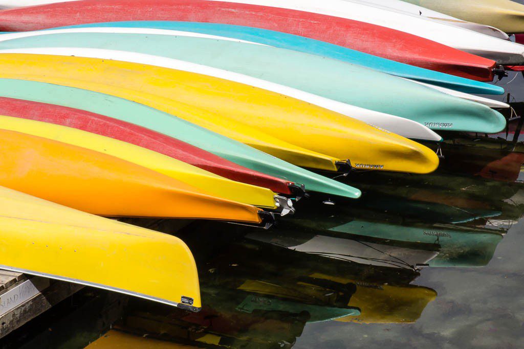 Colorful row of rental kayaks