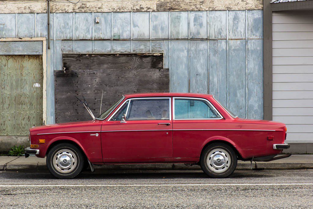 Liked this old red car in front of the blue building