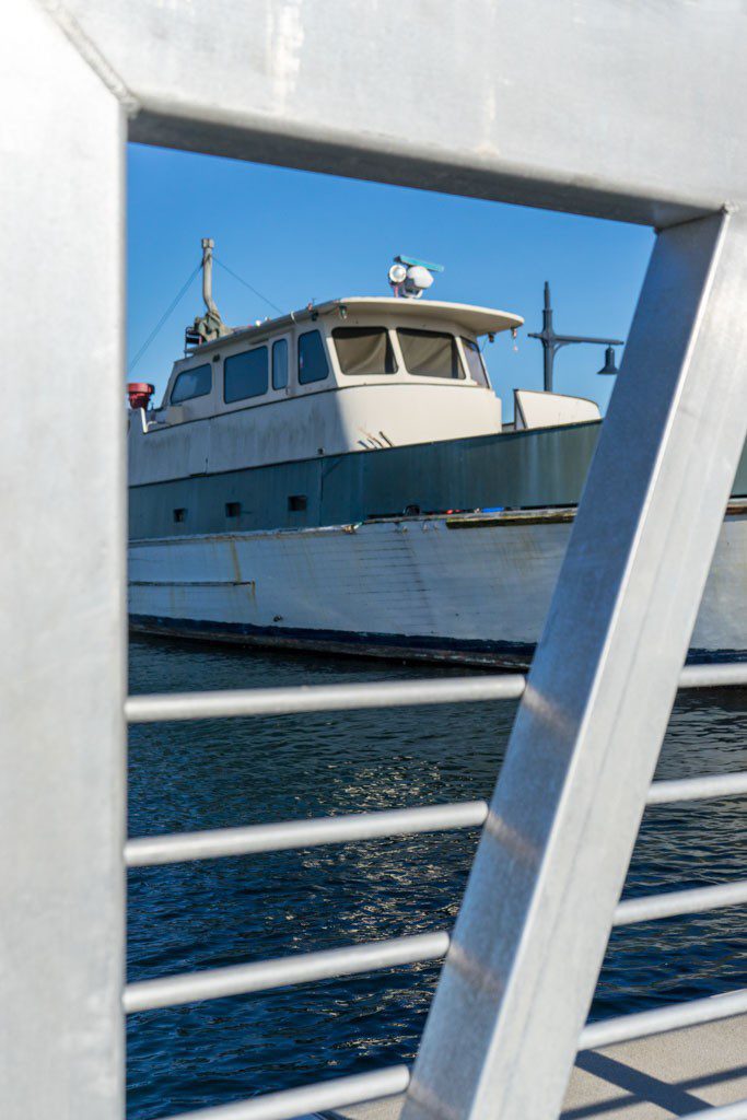 Using the railing as framing for the boat behind.