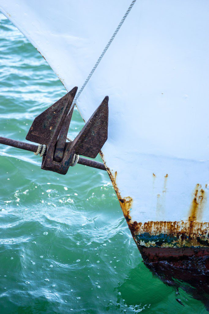 I like the shape made by the bow of the boat and the anchor adds the interest needed to make the photo work.