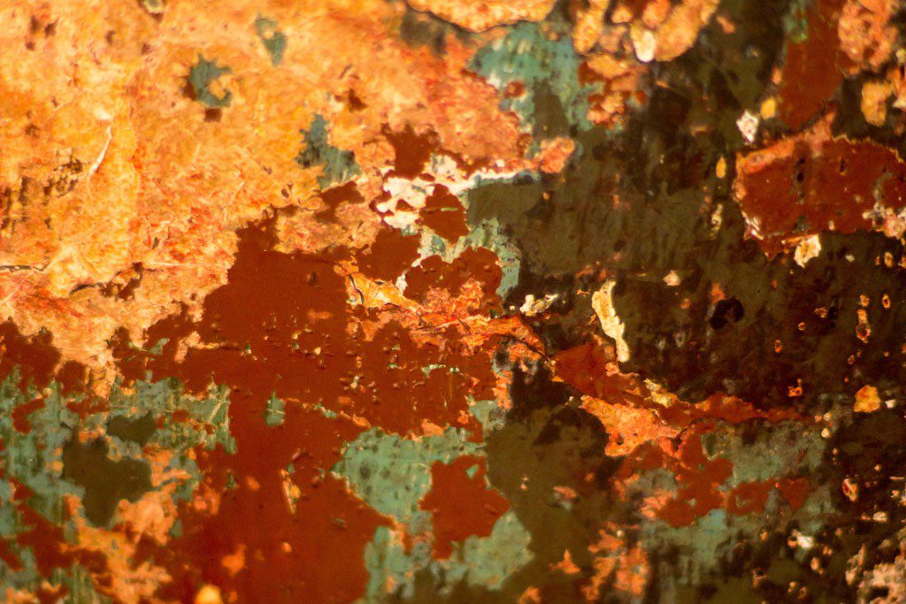 Many layers of paint turn into many layers of rust.