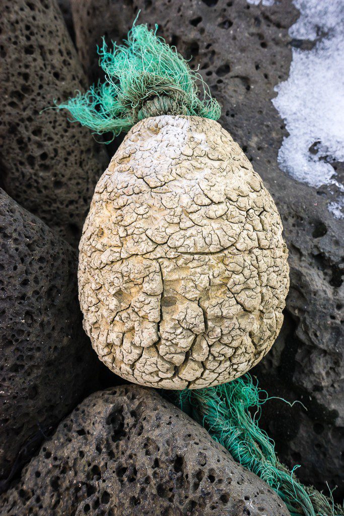 Old buoy that ironically looks like a pineapple out of place...