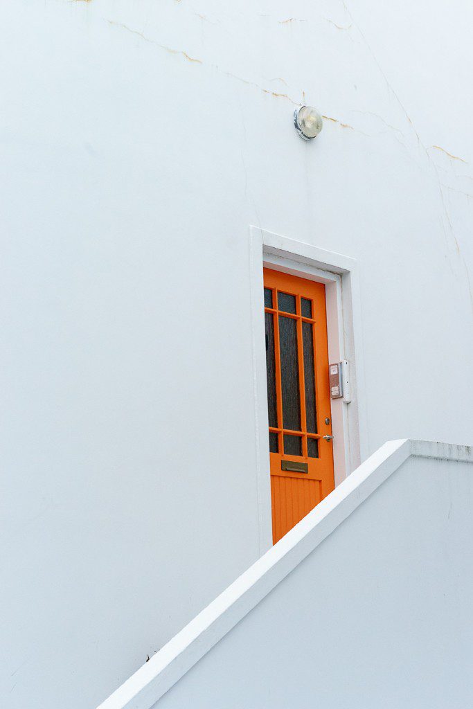 Orange door on white