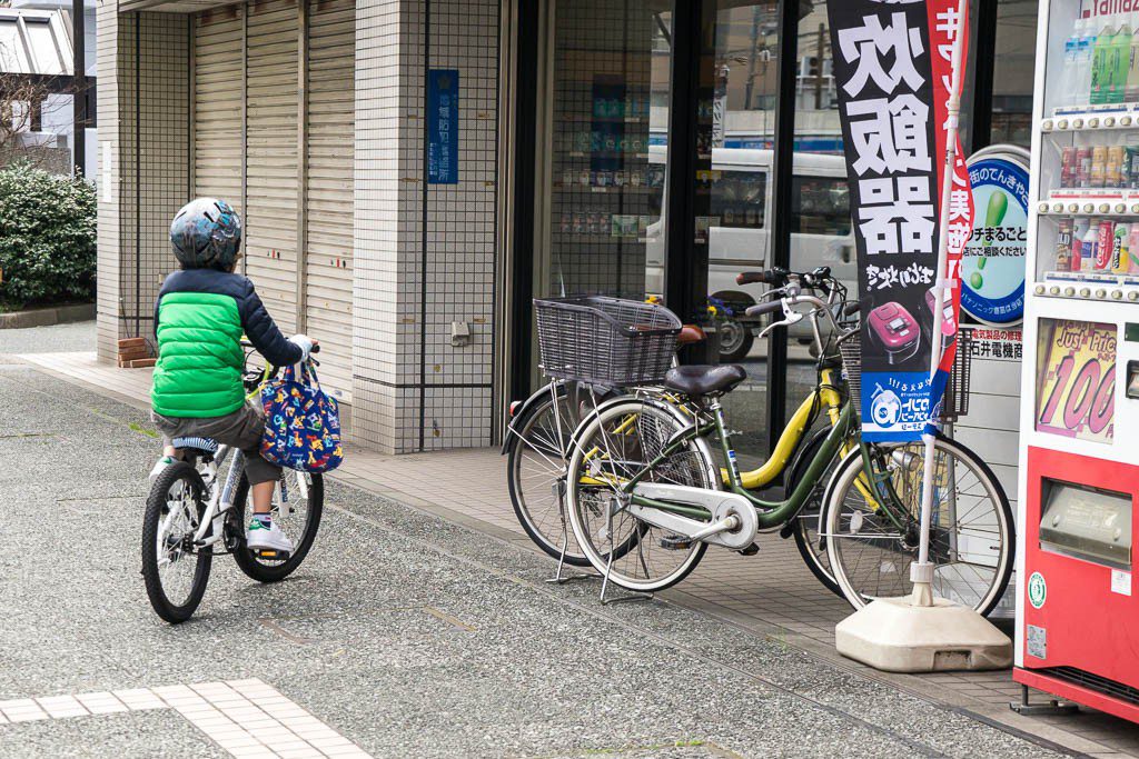 Little kid learning to ride a bike