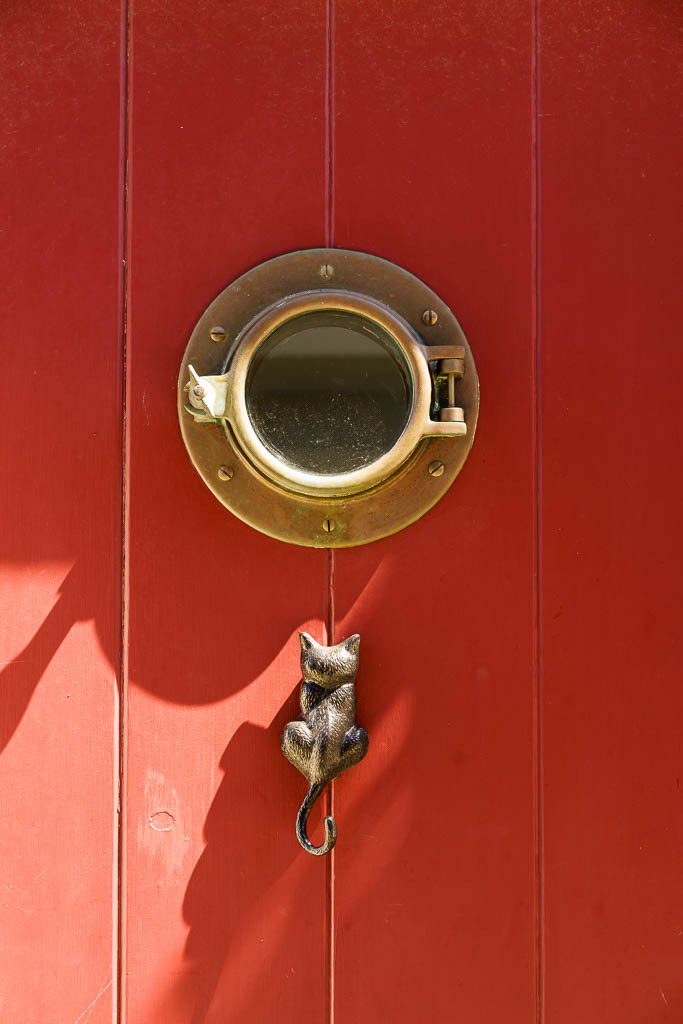 Cat door knocker and porthole window.