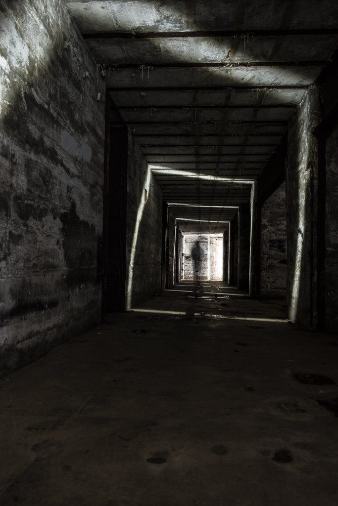 Jason walking down the hall while spinning the flashlight